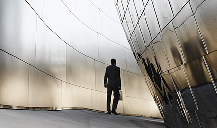Geschäftsmann blickt zuversichtlich aus dem Fenster – Partnerschaft und Wachstum durch professionellen Vertriebsservice.