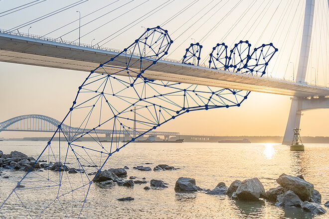A symbolic supporting hand beneath a bridge – reliability, and innovation at IPConcept.